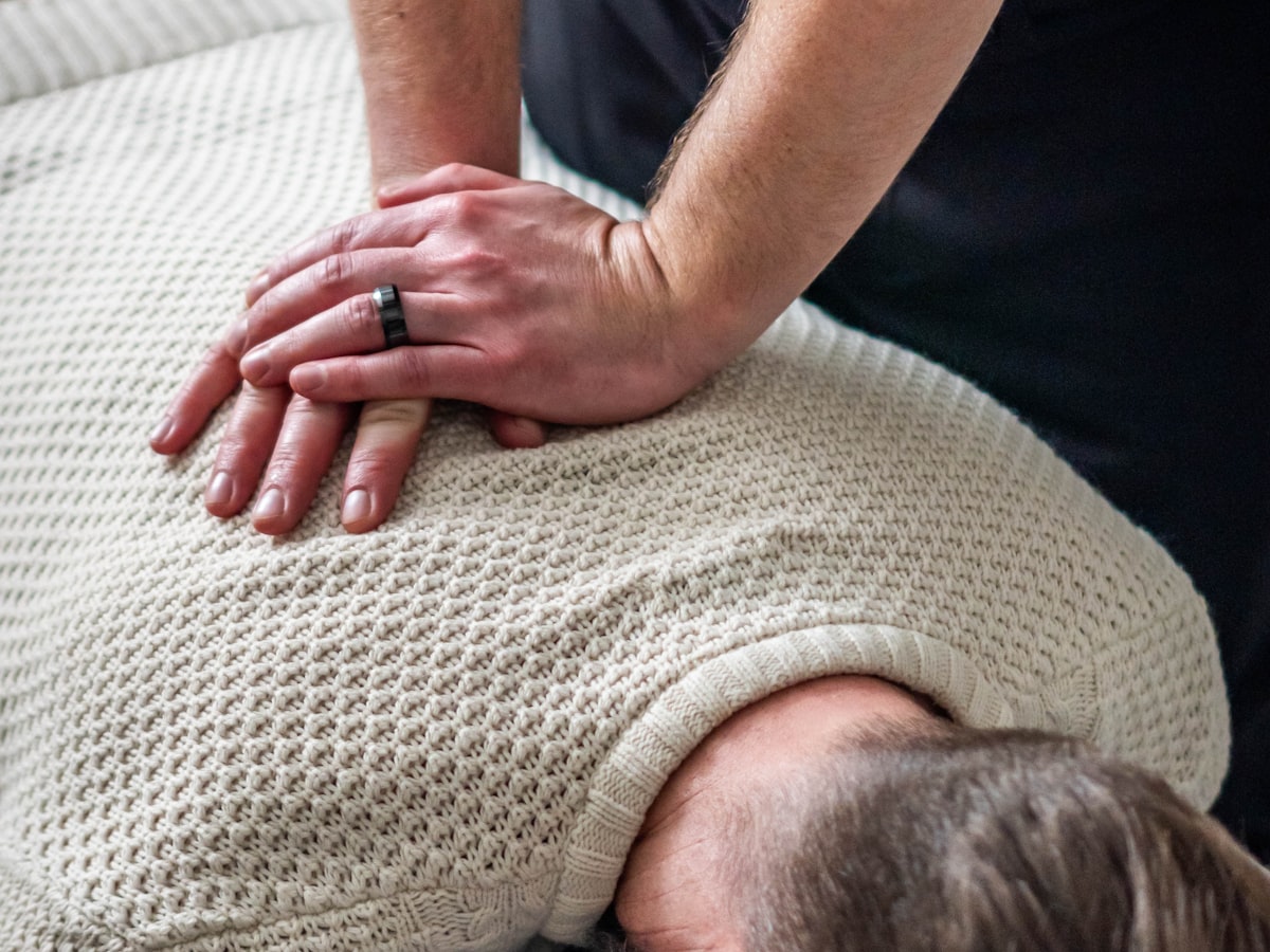 Chiropractor performing a gentle upper-back adjustment at Anchor Chiropractic in London