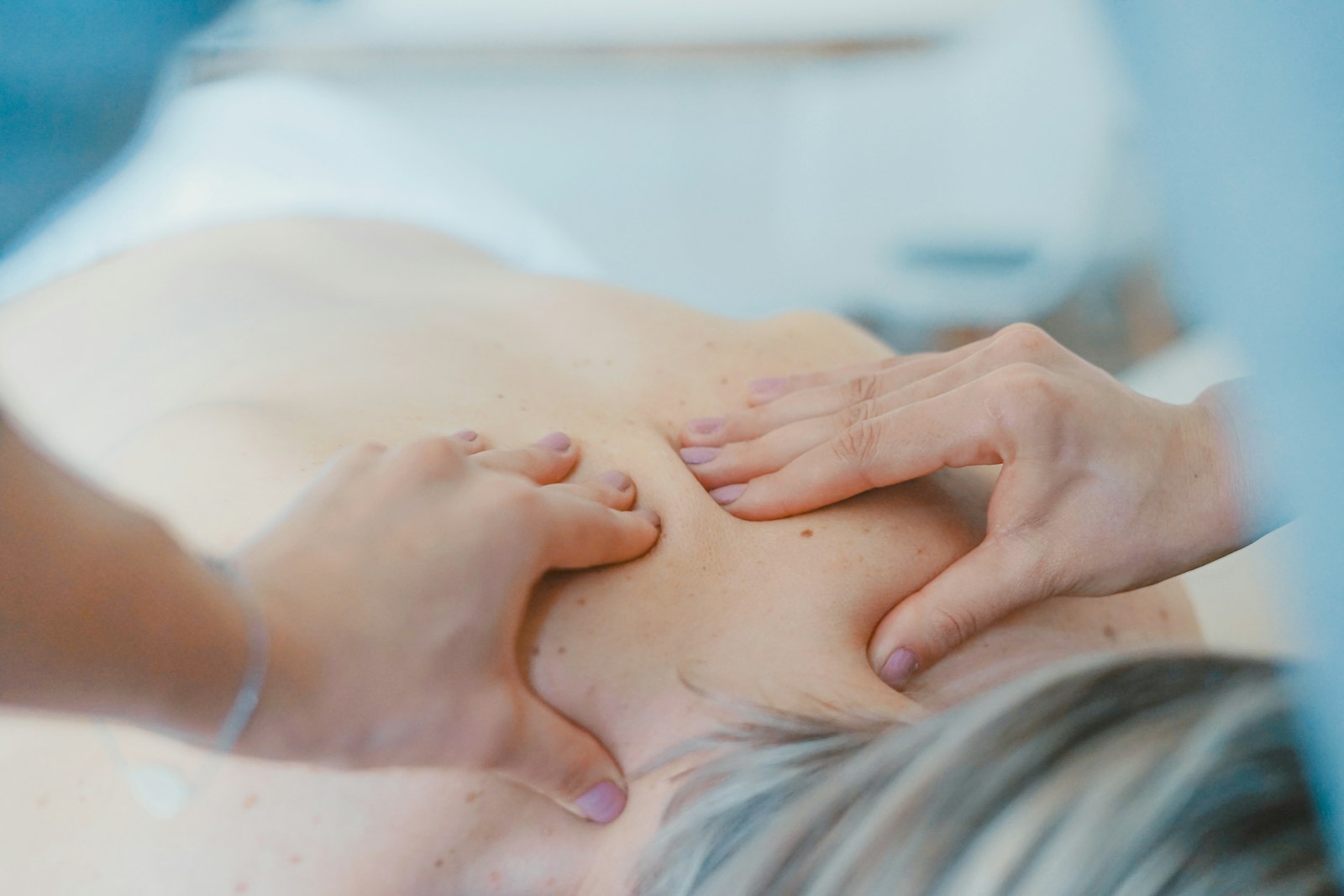 Chiropractor treating a patient's lower back in the London clinic