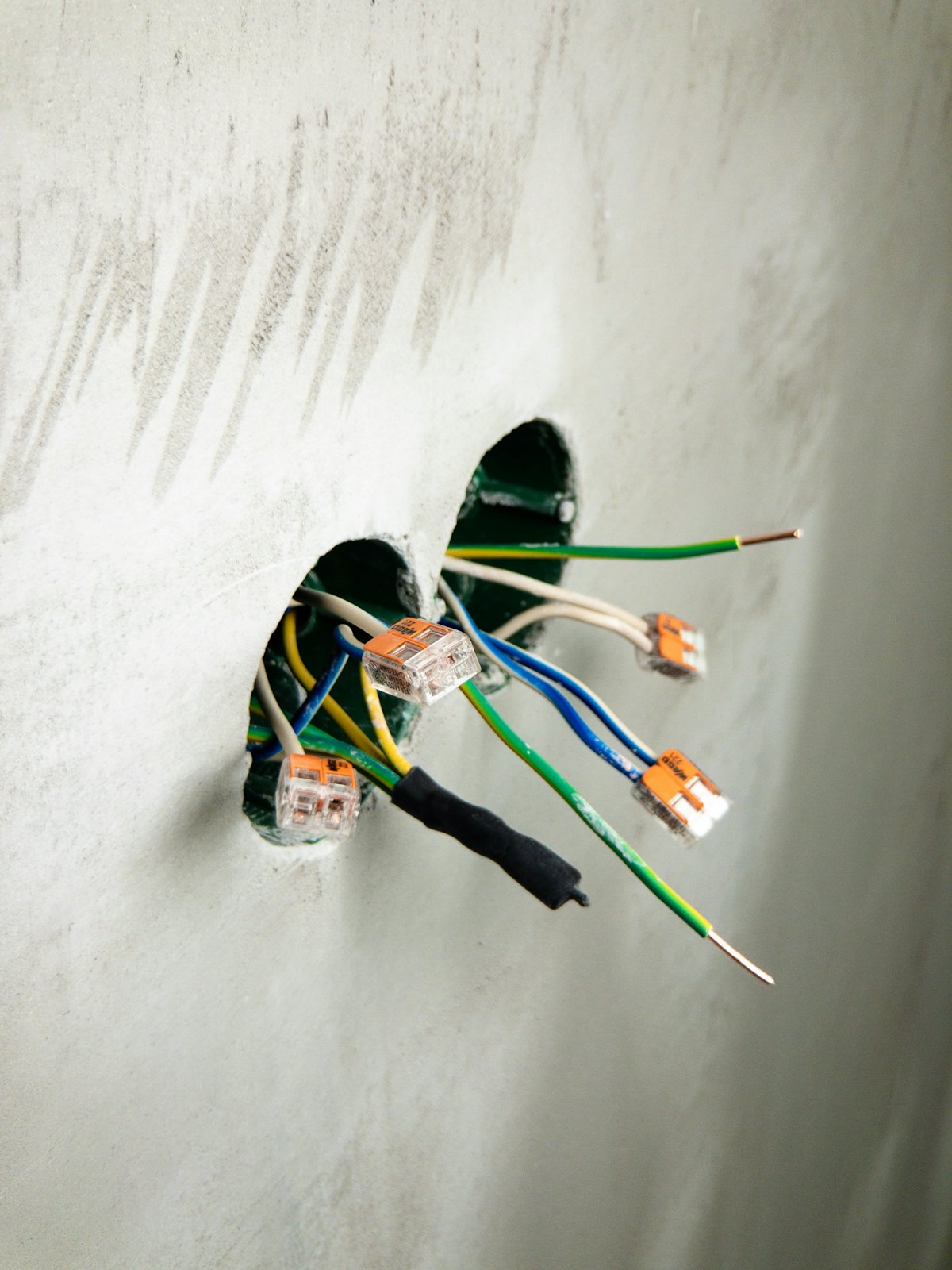Wall box connections opened up and corrected during wiring remediation work in a Guelph area home