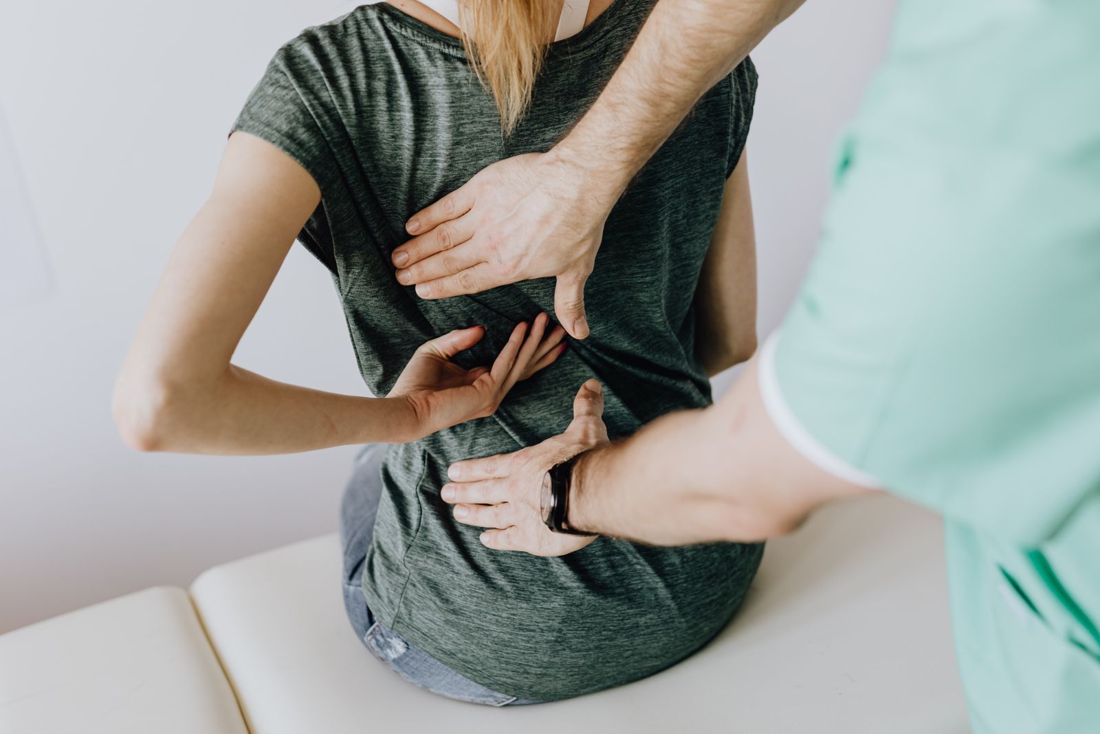 Physiotherapist assessing a patient's lower back at Stride Physiotherapy in Kitchener