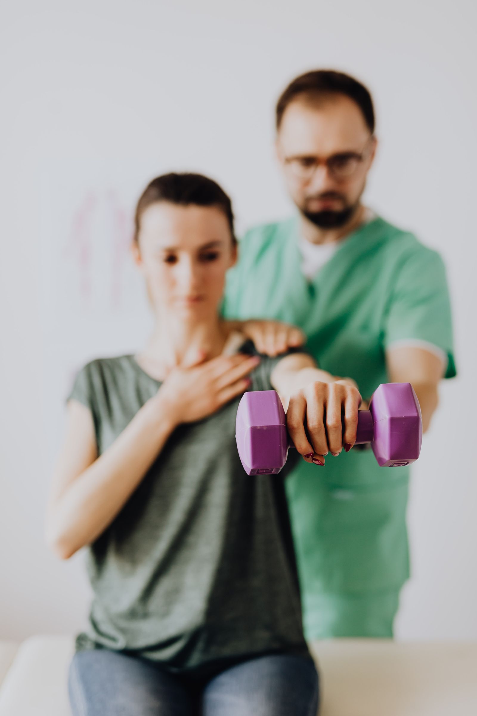 A physiotherapist guiding a strengthening exercise at Stride Physiotherapy in Kitchener