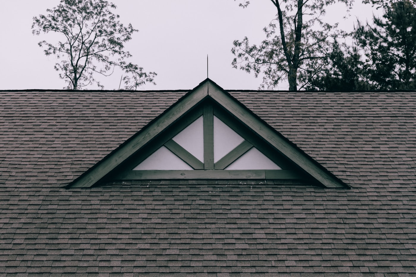 Steep asphalt shingle roof and gable dormer on a village home in Lakefield