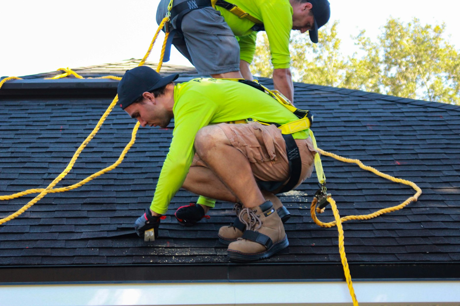 Crew finishing the shingle detail at the roof edge of a cottage near Bridgenorth